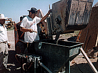 Wet shotcrete machine being filled.